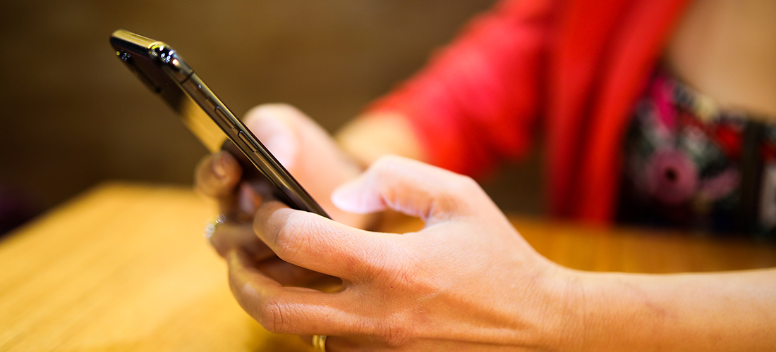 7 best practices for designing mobile navigation. Image depicts a woman using a mobile device