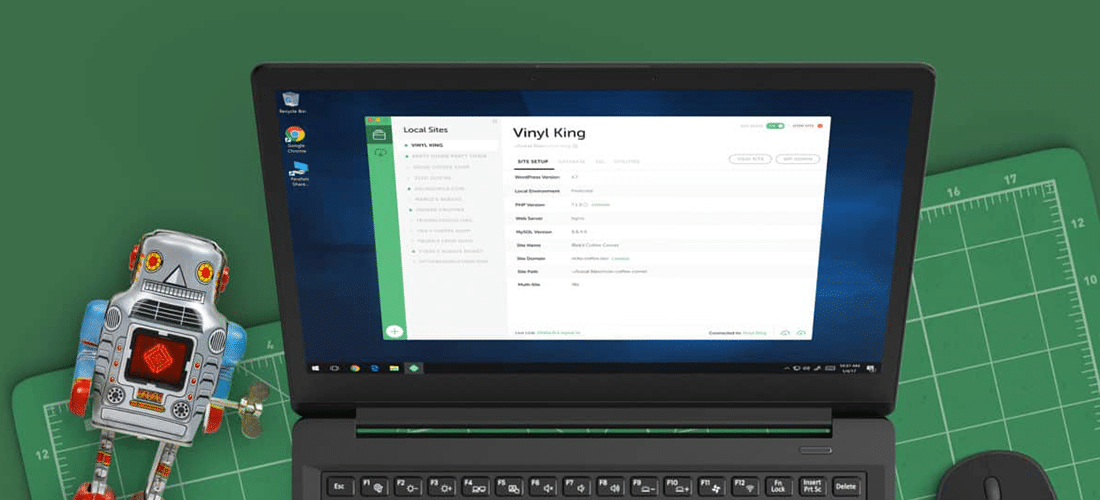 laptop open to Local with the Local mascot robot next to it