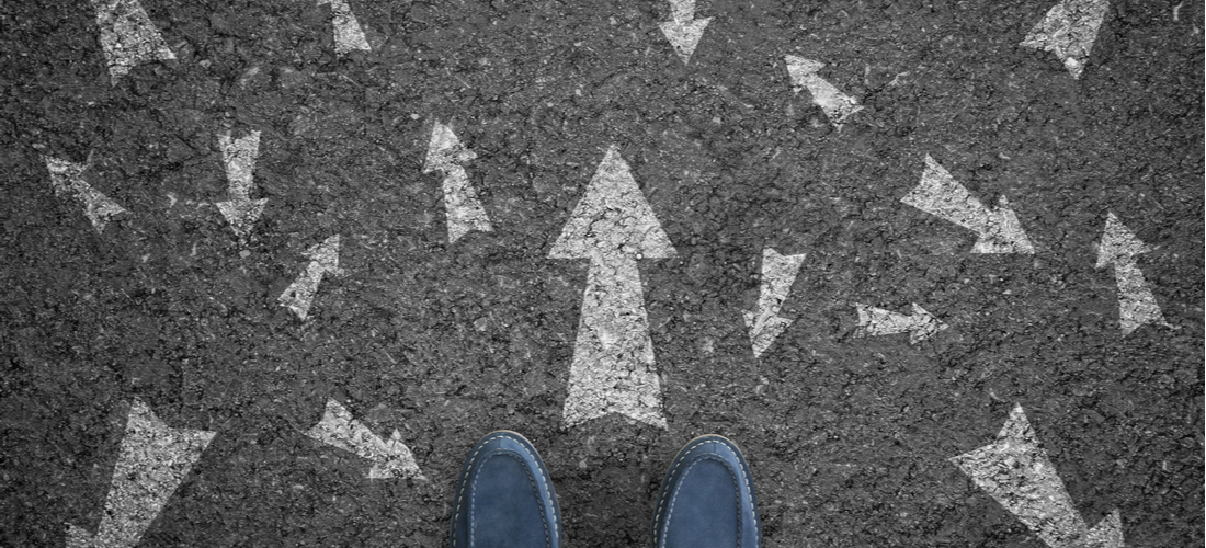 Photograph taken from above of a blue pair of shoes facing out to customer journey arrows