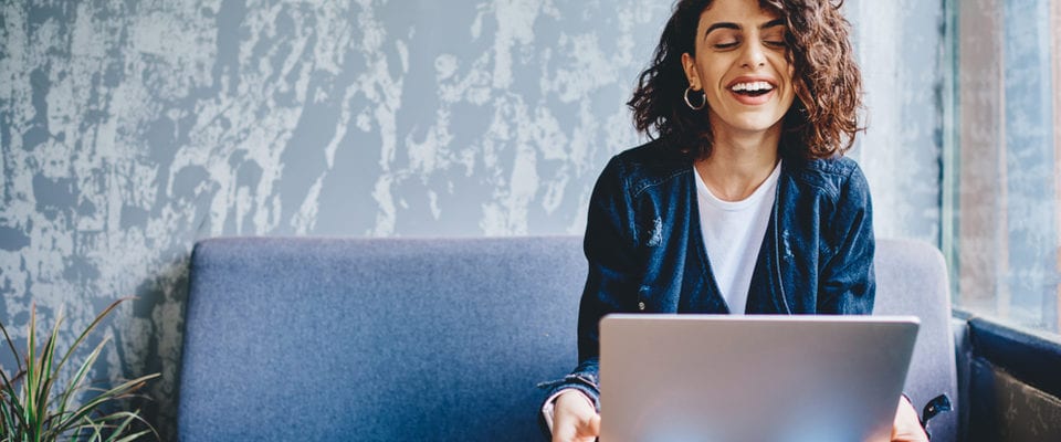 Happy stylish female blogger laughing