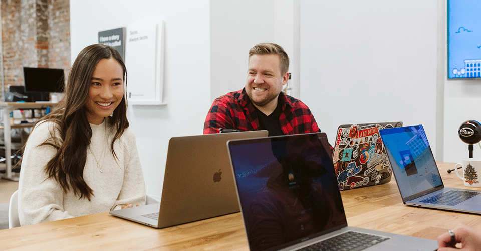 coworkers share a laugh while working on a project