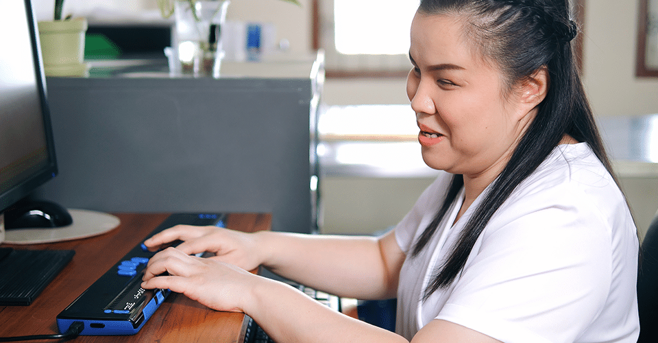 Visually impaired women using braille-enabled keyboard