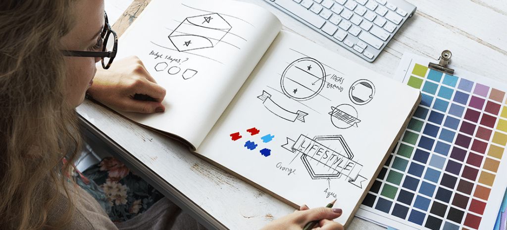 a woman ideates on potential logos while working on a brand style guide