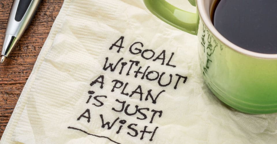 Napkin with a note reading "a goal without a plan is just a wish"