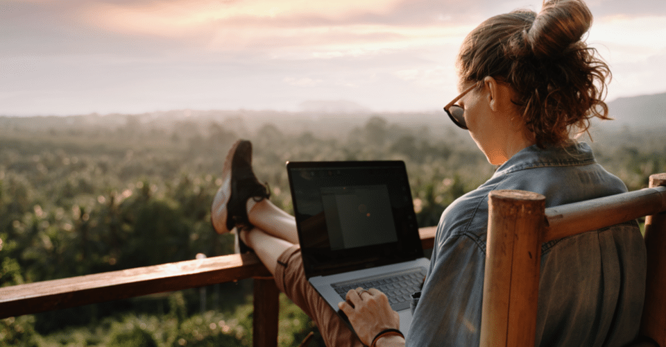 Woman using laptop on deck WordPress design