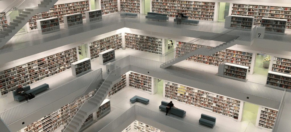 Modern all white library filled with books and staircases