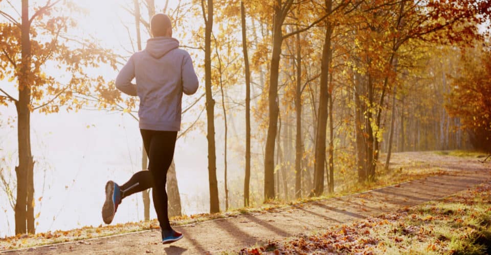 5 Ways to Reduce Initial Server Response Time. person in hoodie running in morning light on trail