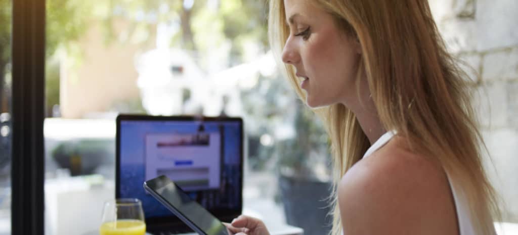 woman sitting at desk waiting on website to load