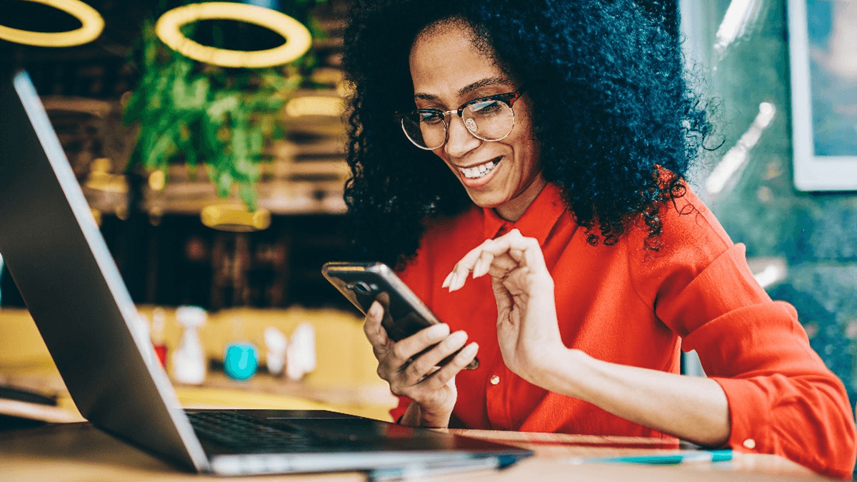 A woman checks her website on a mobile device. How To Use The WordPress REST API Plugin